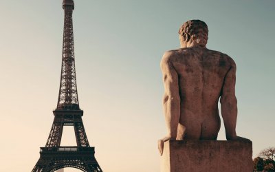 Eiffel Tower with statue as the famous city landmark in Paris